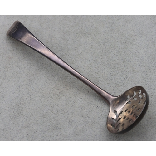 341 - A Georgian silver sifter spoon with engraved crest, maker's mark CB/TB, 0.82oz