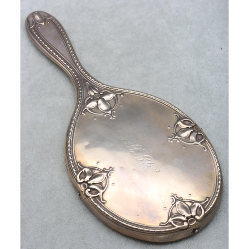 370 - An Edward VII silver hand mirror with allover embossed leaf and scroll decoration, London 1907, make... 