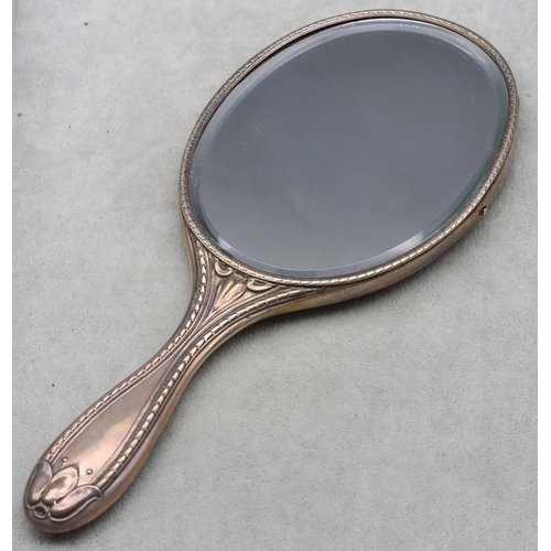 370 - An Edward VII silver hand mirror with allover embossed leaf and scroll decoration, London 1907, make... 