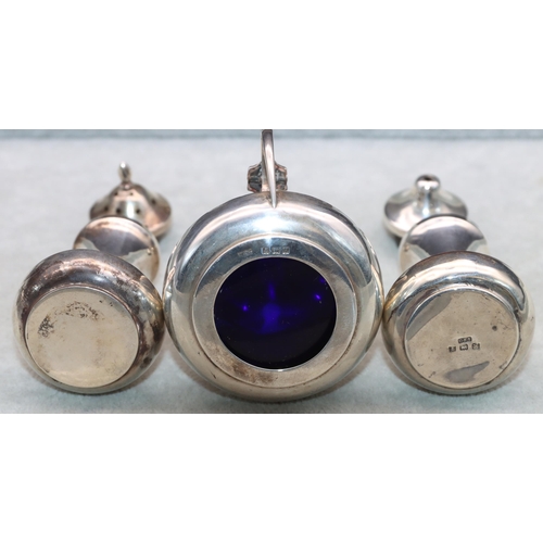 371 - A 3-piece Birmingham silver round bulbous shaped condiment set comprising of mustard with blue glass... 