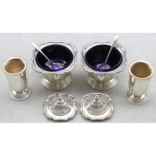 396 - A 4-piece Sheffield silver condiment set comprising of a pair of salts with blue glass liners and sp... 