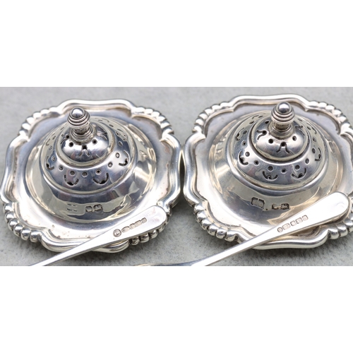 396 - A 4-piece Sheffield silver condiment set comprising of a pair of salts with blue glass liners and sp... 