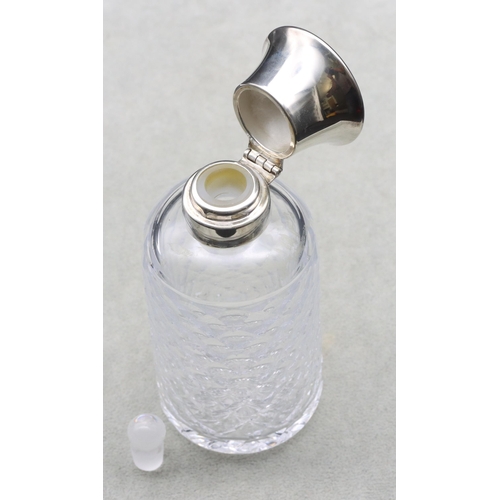 397 - A cut glass round scent bottle with thumb pattern decoration, Birmingham silver neck and hinged lid ... 