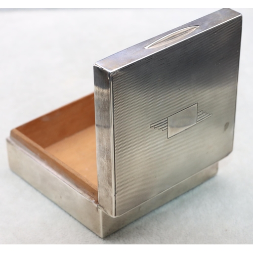 402 - A London silver square cigarette box with engine turned hinged lid enclosing a cedar lined interior,... 