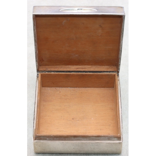 402 - A London silver square cigarette box with engine turned hinged lid enclosing a cedar lined interior,... 