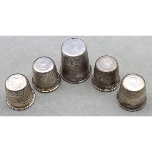 406 - A set of 4 silver plated shot glasses in the form of thimbles and a similar larger thimble (5)