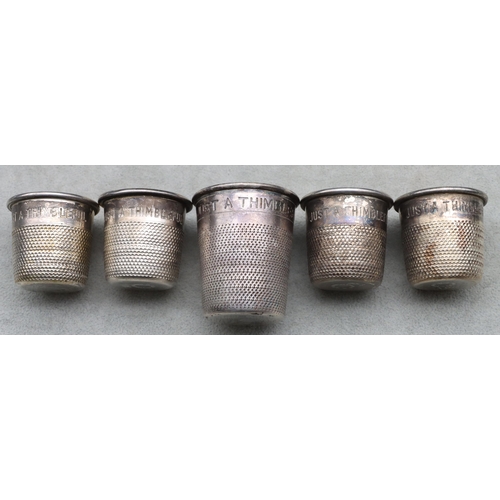 406 - A set of 4 silver plated shot glasses in the form of thimbles and a similar larger thimble (5)