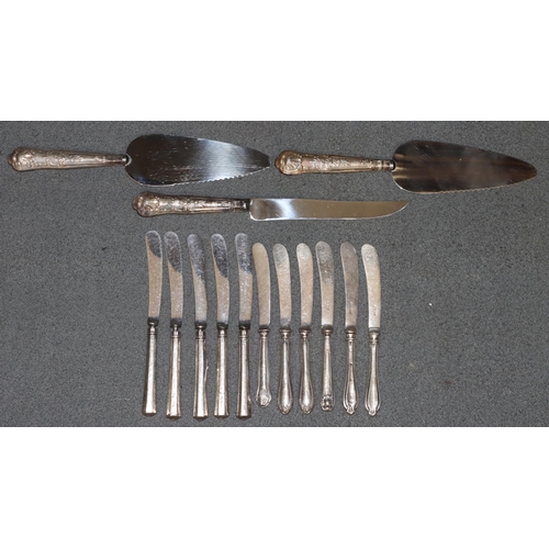 413 - 2 silver handled cake slices, a similar silver handled bread knife and 11 various silver handled but... 