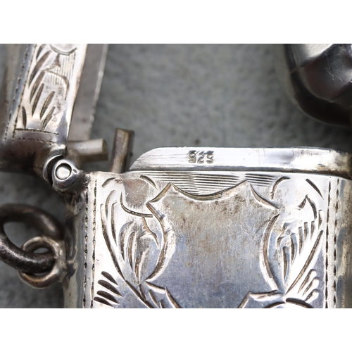 416 - A 925 small silver vesta case with hinged lid (damage to lid) and a silver plated embossed vesta cas... 