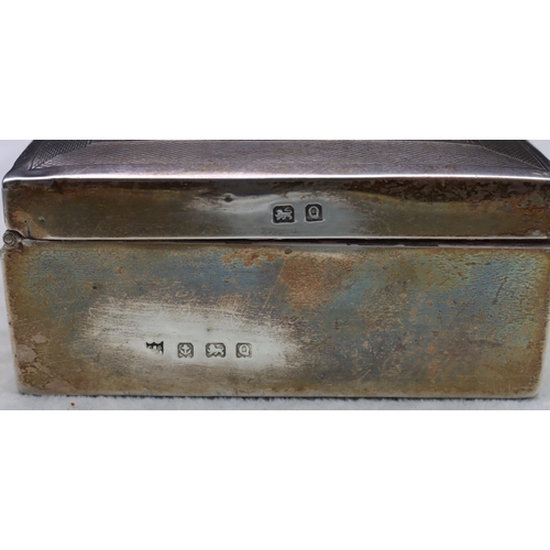 419 - A Birmingham silver rectangular shaped cigarette box with engine turned hinged lid enclosing cedar l... 