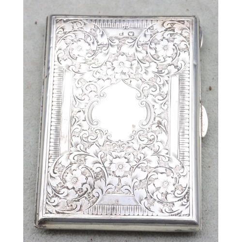 420 - A Victorian Birmingham silver card case with allover bright cut floral and scroll decoration, hinged... 