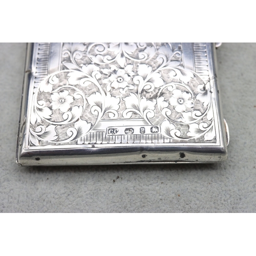 420 - A Victorian Birmingham silver card case with allover bright cut floral and scroll decoration, hinged... 