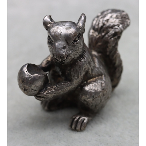 422 - A cast silver model of a squirrel holding a half-eaten nut, 4cm high,3.1oz