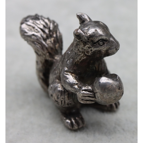 422 - A cast silver model of a squirrel holding a half-eaten nut, 4cm high,3.1oz