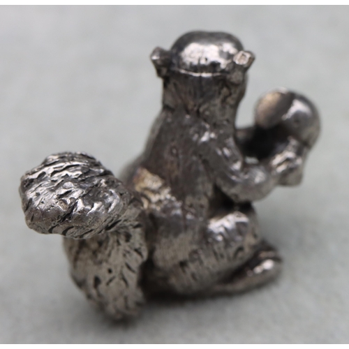 422 - A cast silver model of a squirrel holding a half-eaten nut, 4cm high,3.1oz