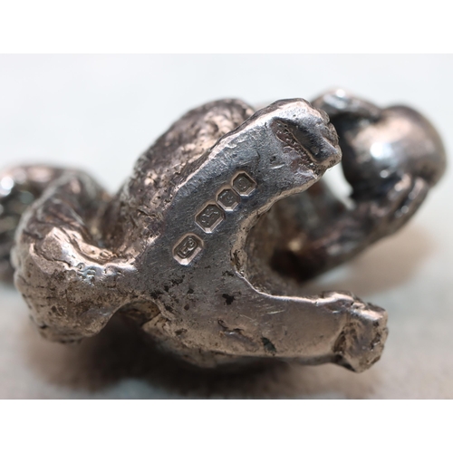 422 - A cast silver model of a squirrel holding a half-eaten nut, 4cm high,3.1oz