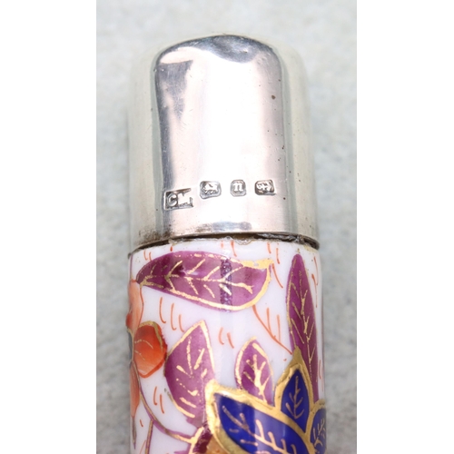 429 - A George V china and silver topped scent bottle with coloured floral and leaf decoration