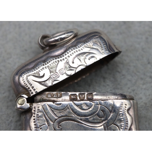 430 - A Chester silver small vesta case with engraved floral and scroll decoration, hinged lid