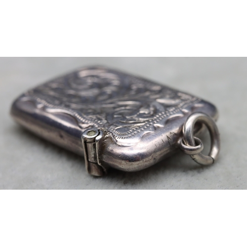 430 - A Chester silver small vesta case with engraved floral and scroll decoration, hinged lid