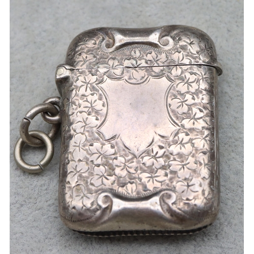 434 - A Victorian silver vesta case with allover leaf and scroll decoration, hinged lid