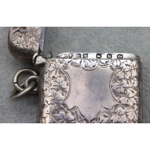 434 - A Victorian silver vesta case with allover leaf and scroll decoration, hinged lid