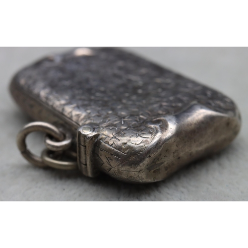 434 - A Victorian silver vesta case with allover leaf and scroll decoration, hinged lid