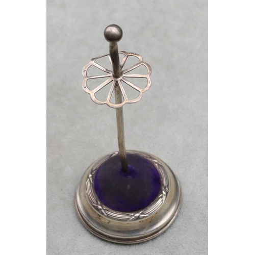 438 - A George V silver standing hat pin on round sweeping base, 14cm high