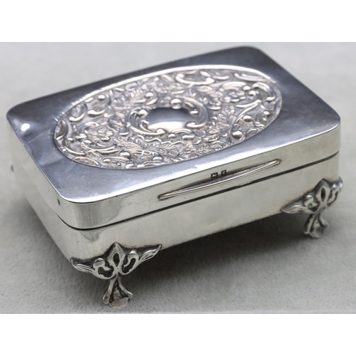 440 - An Edward VII silver rectangular trinket box with hinged lid, embossed floral and scroll decoration,... 