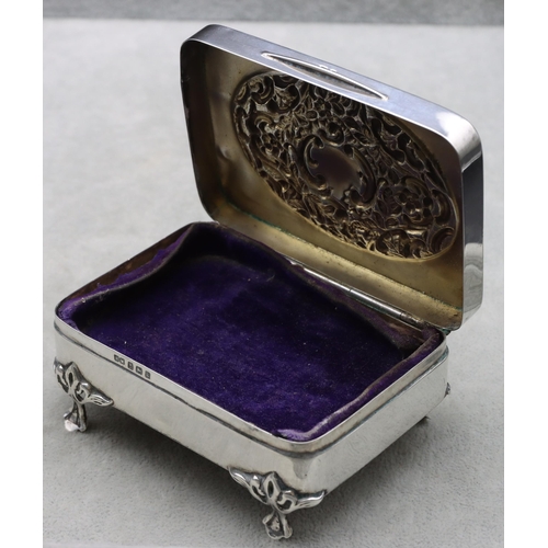 440 - An Edward VII silver rectangular trinket box with hinged lid, embossed floral and scroll decoration,... 