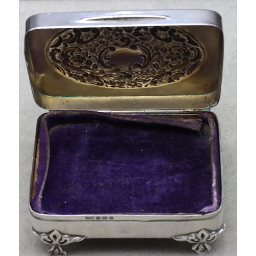 440 - An Edward VII silver rectangular trinket box with hinged lid, embossed floral and scroll decoration,... 