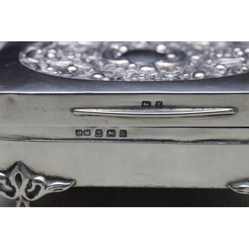 440 - An Edward VII silver rectangular trinket box with hinged lid, embossed floral and scroll decoration,... 