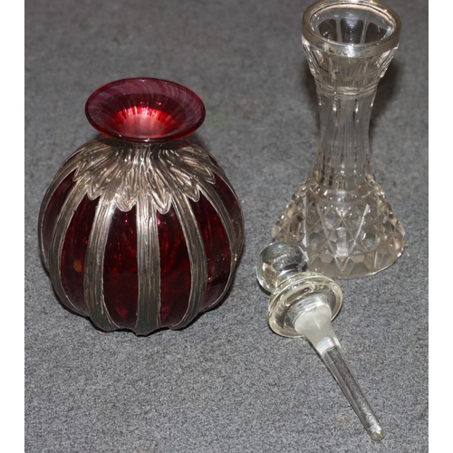 444 - A ruby and clear glass round bulbous thin necked scent bottle with part silver covering, 12cm high a... 