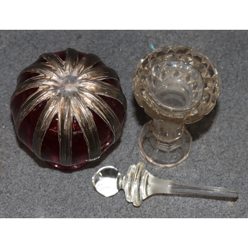 444 - A ruby and clear glass round bulbous thin necked scent bottle with part silver covering, 12cm high a... 