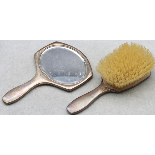 450 - A Birmingham silver small hand mirror with engine turned decoration with matching brush (2)