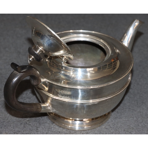 459 - A George V silver round bulbous shaped teapot with ebony finial and handle, London 1919, maker Golds... 