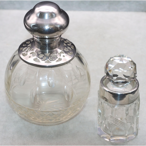 463 - A cut glass round bulbous shaped scent bottle with London silver neck and hinged lid (hinge a/f), en... 