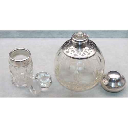 463 - A cut glass round bulbous shaped scent bottle with London silver neck and hinged lid (hinge a/f), en... 