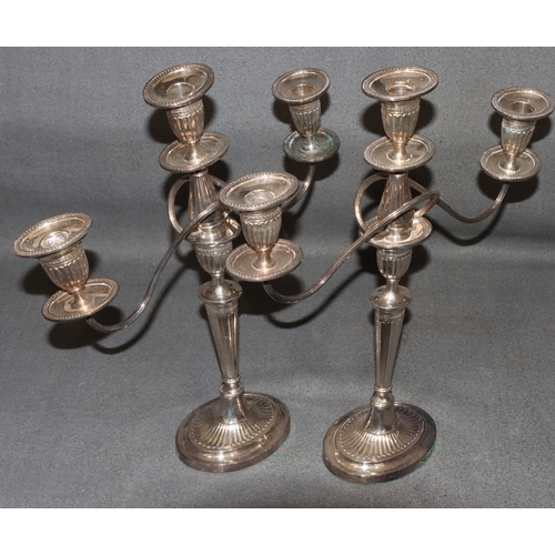 467 - A pair of silver plated candelabras with scroll shaped arms, turned stems on oval sweeping bases (1 ... 