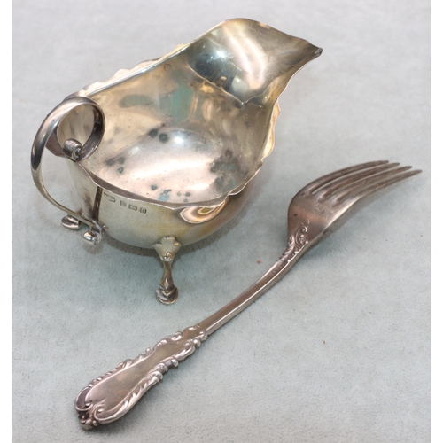 469 - A Birmingham silver sauce boat with crinkle handle on splayed hoof feet and a sterling silver fork, ... 