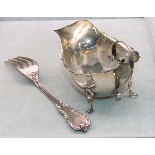 469 - A Birmingham silver sauce boat with crinkle handle on splayed hoof feet and a sterling silver fork, ... 