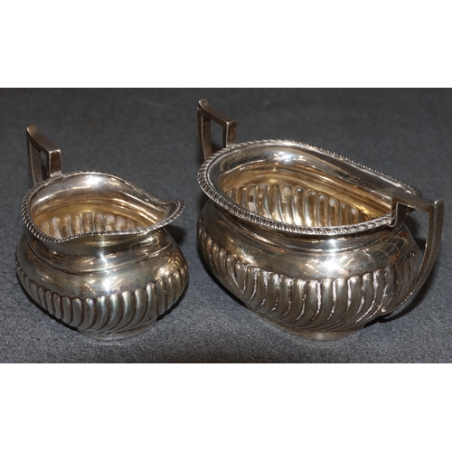 470 - An Edward VII silver rectangular bulbous shaped tea service with half embossed reeded decoration, co... 