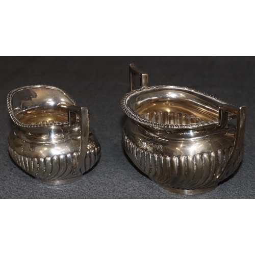 470 - An Edward VII silver rectangular bulbous shaped tea service with half embossed reeded decoration, co... 