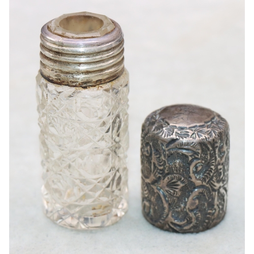 482 - A Victorian cut glass cylindrical scent bottle with embossed leaf and scroll decorated siler screw l... 