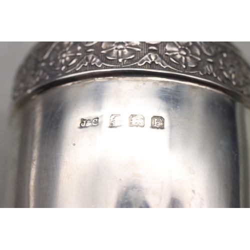 487 - A Birmingham silver small round bulbous thin necked vase with embossed floral and leaf decoration, o... 