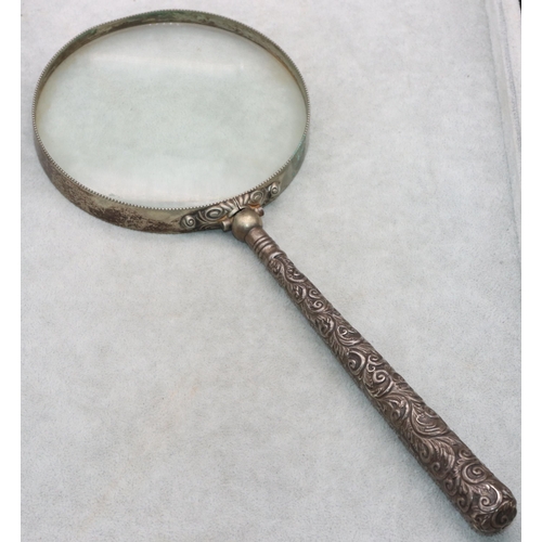 493 - A Birmingham silver handled large tabletop magnifying glass with embossed handle, 31cm long