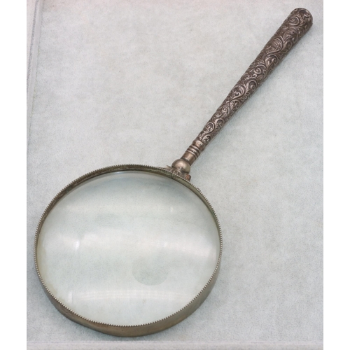 493 - A Birmingham silver handled large tabletop magnifying glass with embossed handle, 31cm long