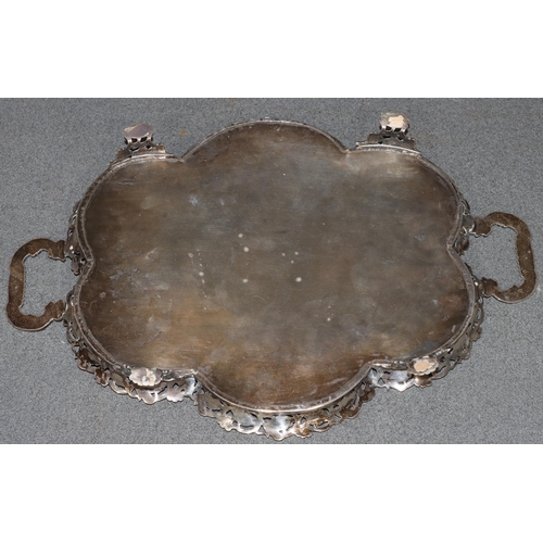 495 - A Continental silver coloured metal 2-handled scallop shaped tray with embossed and pierced floral g... 