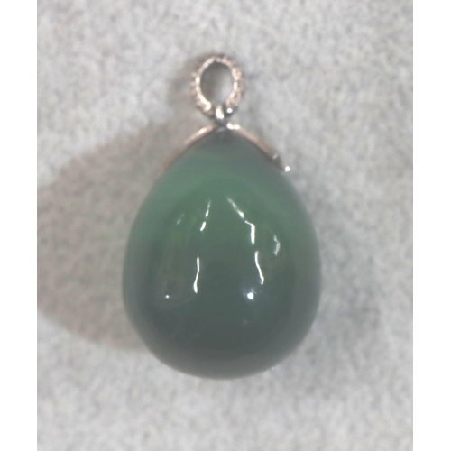 708 - A jade egg shaped pendant with silver clasp inset with small diamonds, 3.2cm high overall