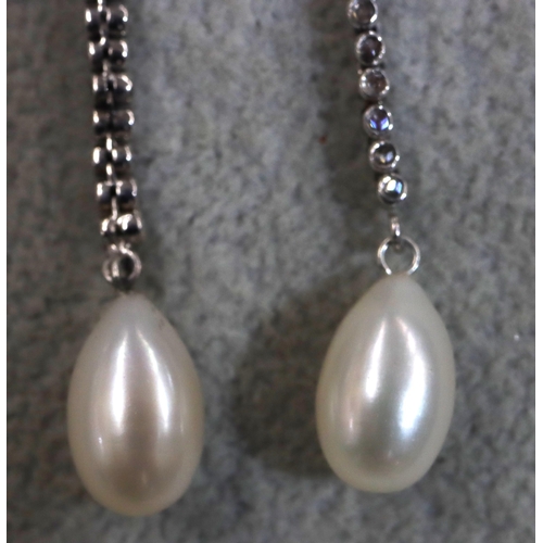 752 - A pair of white gold cultured pearl drop earrings, each set with a line of 10 rough cut diamonds, 4.... 