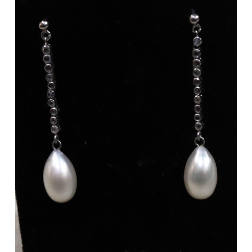 752 - A pair of white gold cultured pearl drop earrings, each set with a line of 10 rough cut diamonds, 4.... 